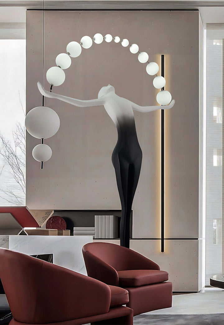 Modern sculptural floor lamp in a stylish living room with elegant furniture and artistic design elements.