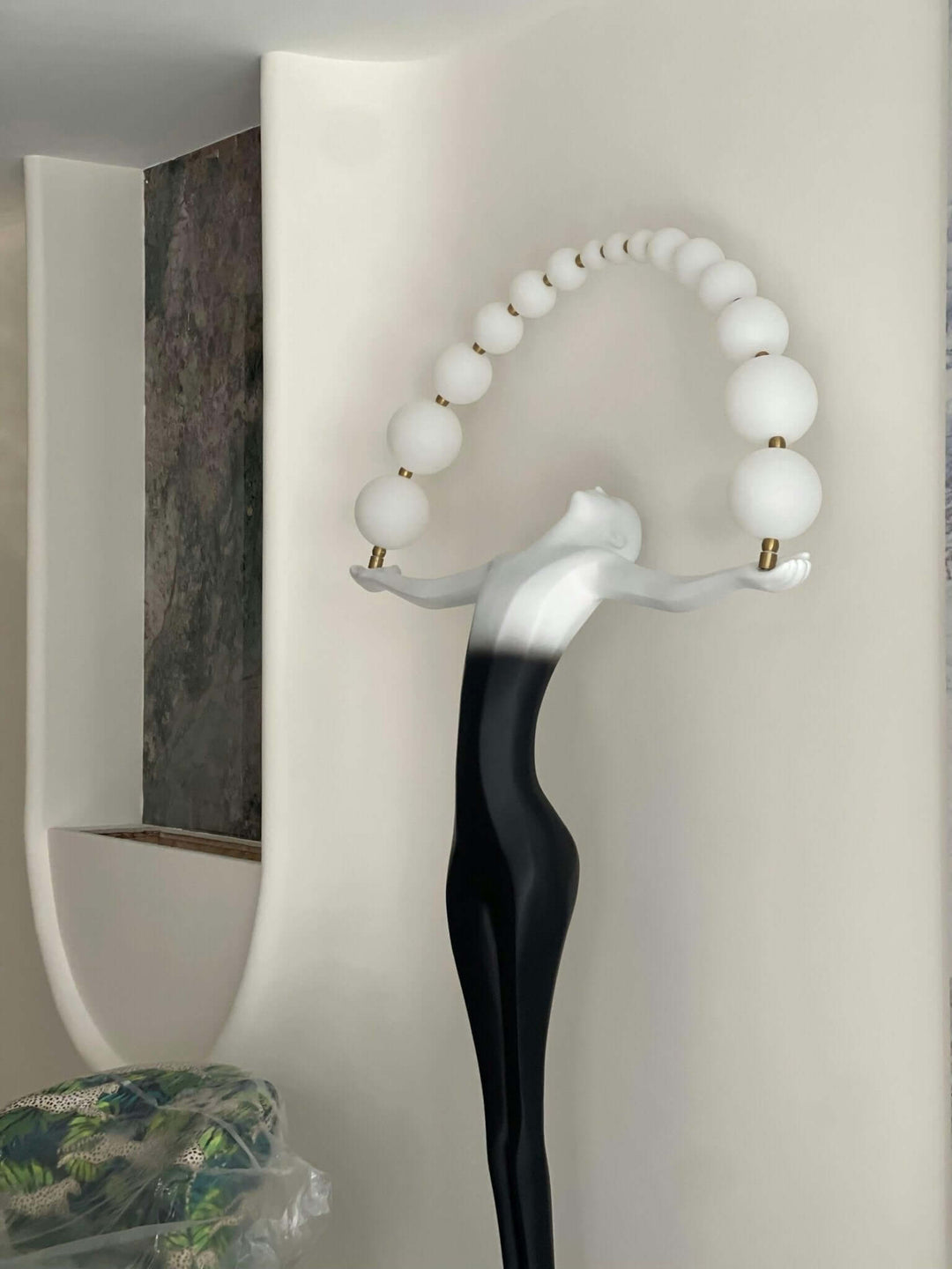 Olyvra sculptural floor lamp with artistic design, featuring sleek lines and orb accents, ideal for living room decor.