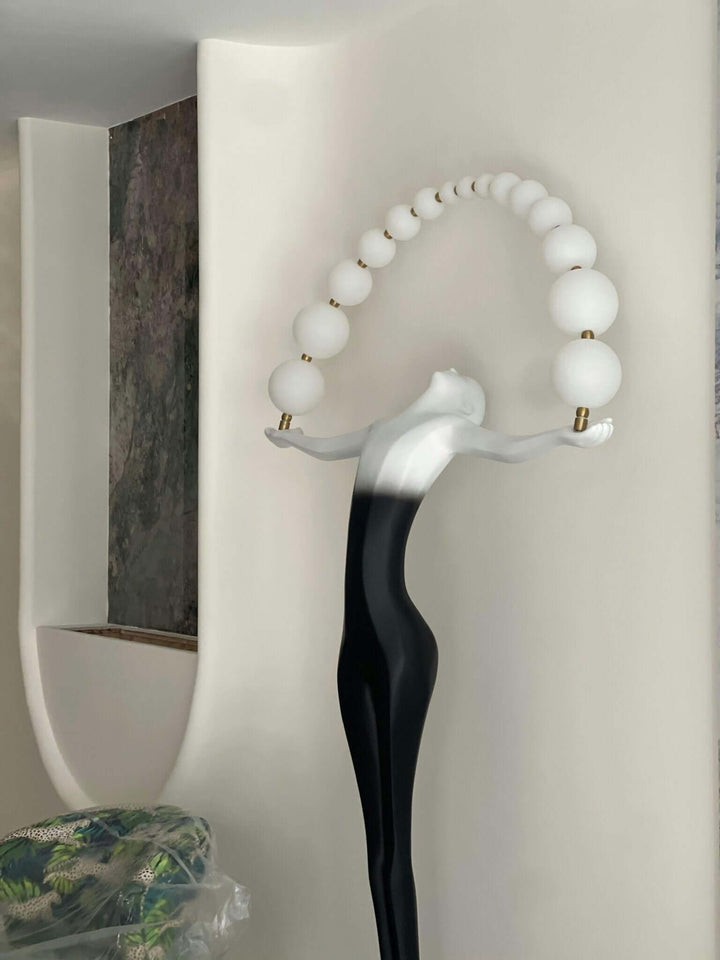 Olyvra sculptural floor lamp with artistic design, featuring sleek lines and orb accents, ideal for living room decor.