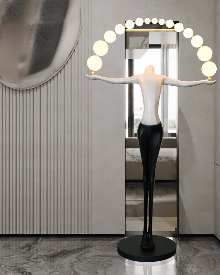 Olyvra sculptural floor lamp with a modern design, featuring a black base and circular light arrangement.