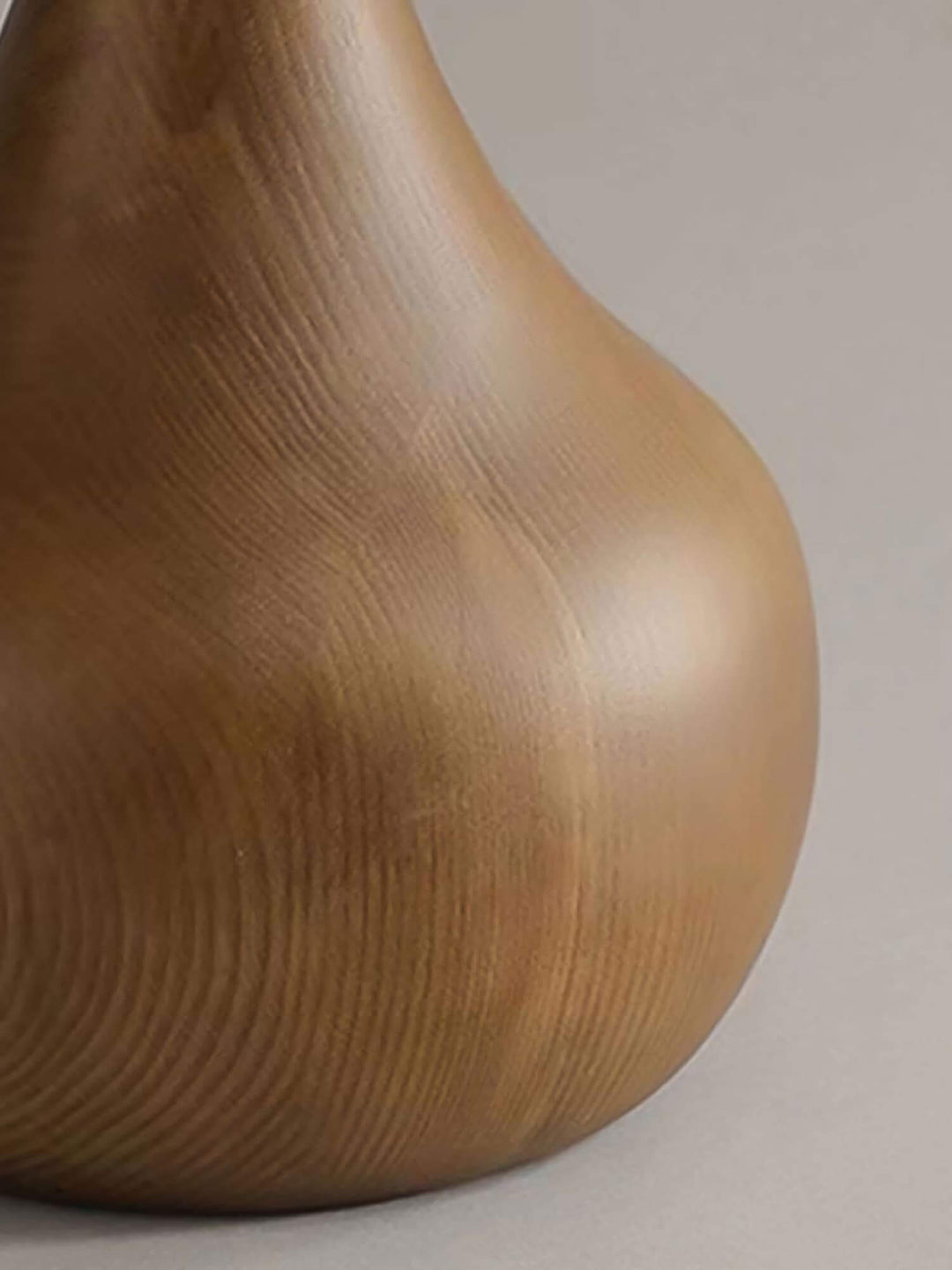 Close-up of a wooden floor lamp base showcasing a rustic design and smooth grain texture.