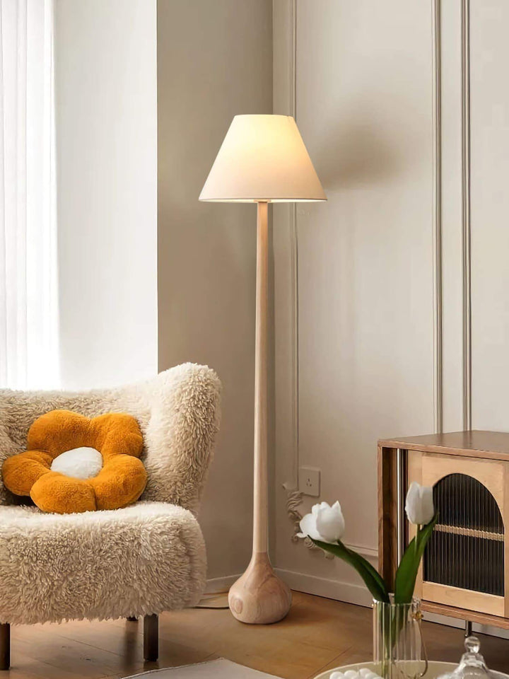Osaka floor lamp in a cozy living room, featuring a rustic wooden design and soft lighting, perfect for adding warmth.