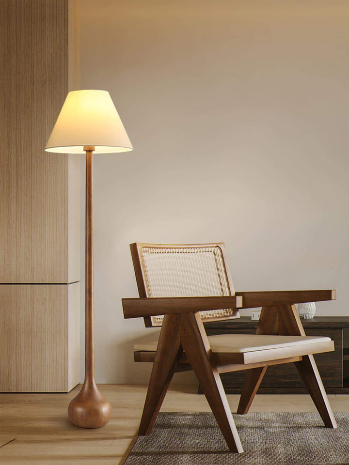 Osaka wooden floor lamp beside a modern chair, perfect floor lights for living room and rustic decor.