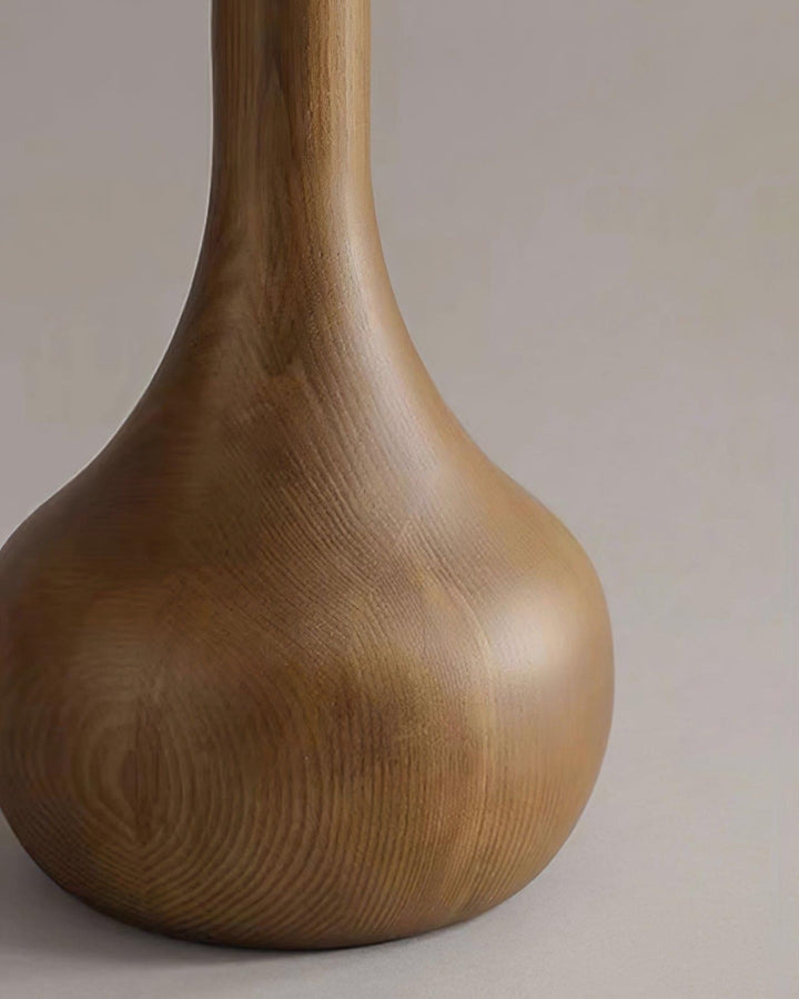 Close-up of a wooden floor lamp base, showcasing its rustic texture and elegant design for living room decor.