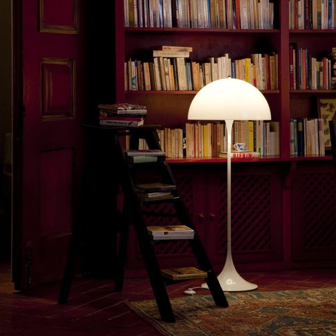 Panthella floor lamp in a cozy library setting, showcasing a modern white acrylic design, perfect for living room decor.