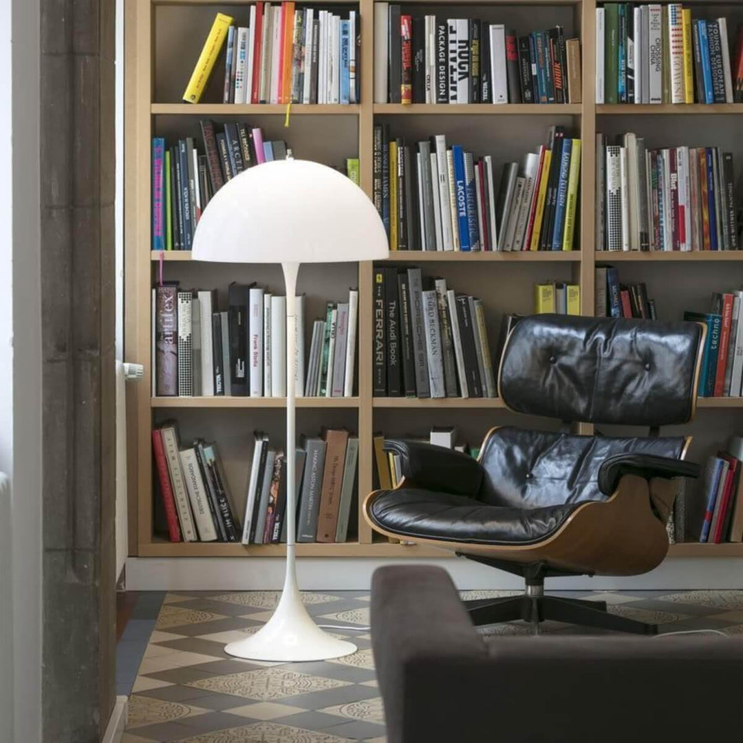 Stylish Panthella floor lamp in white, complementing a modern living room with bookshelves and a cozy chair.