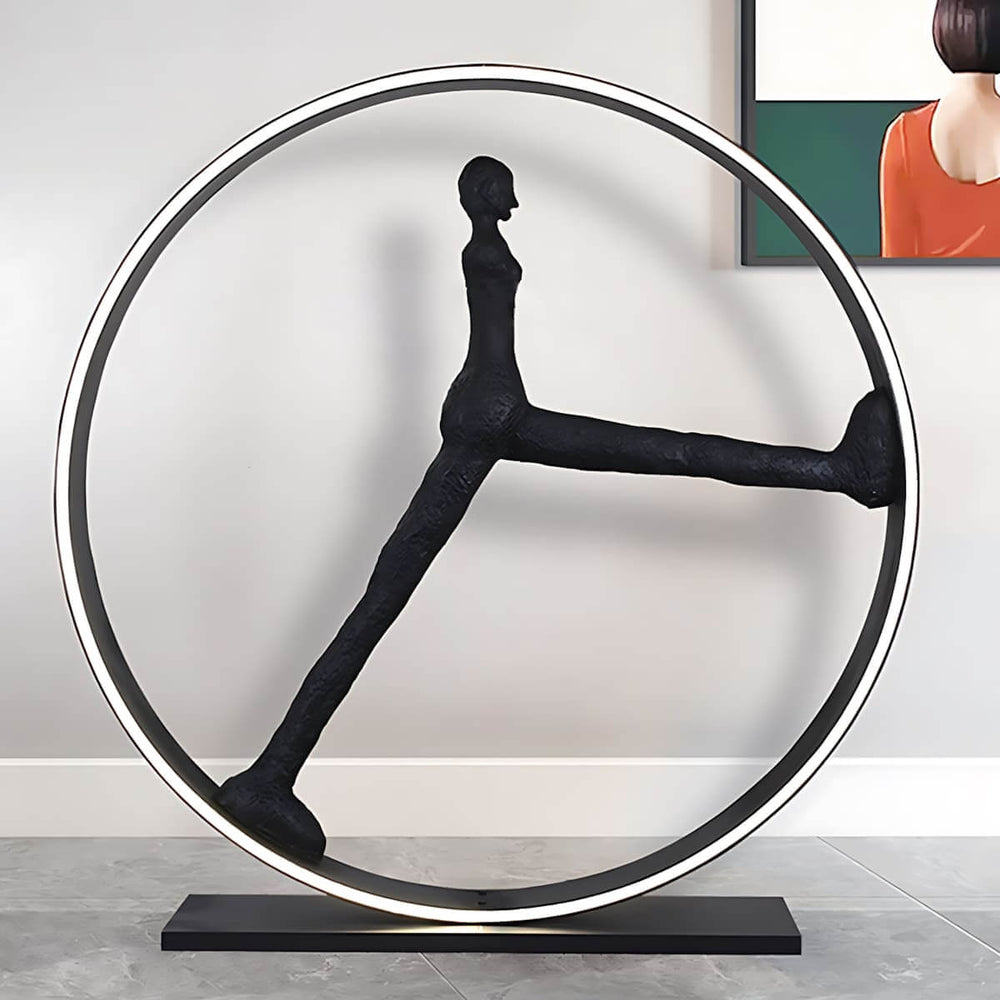 Modern art sculpture feature with abstract human figure in a circular frame, ideal for contemporary home decor.