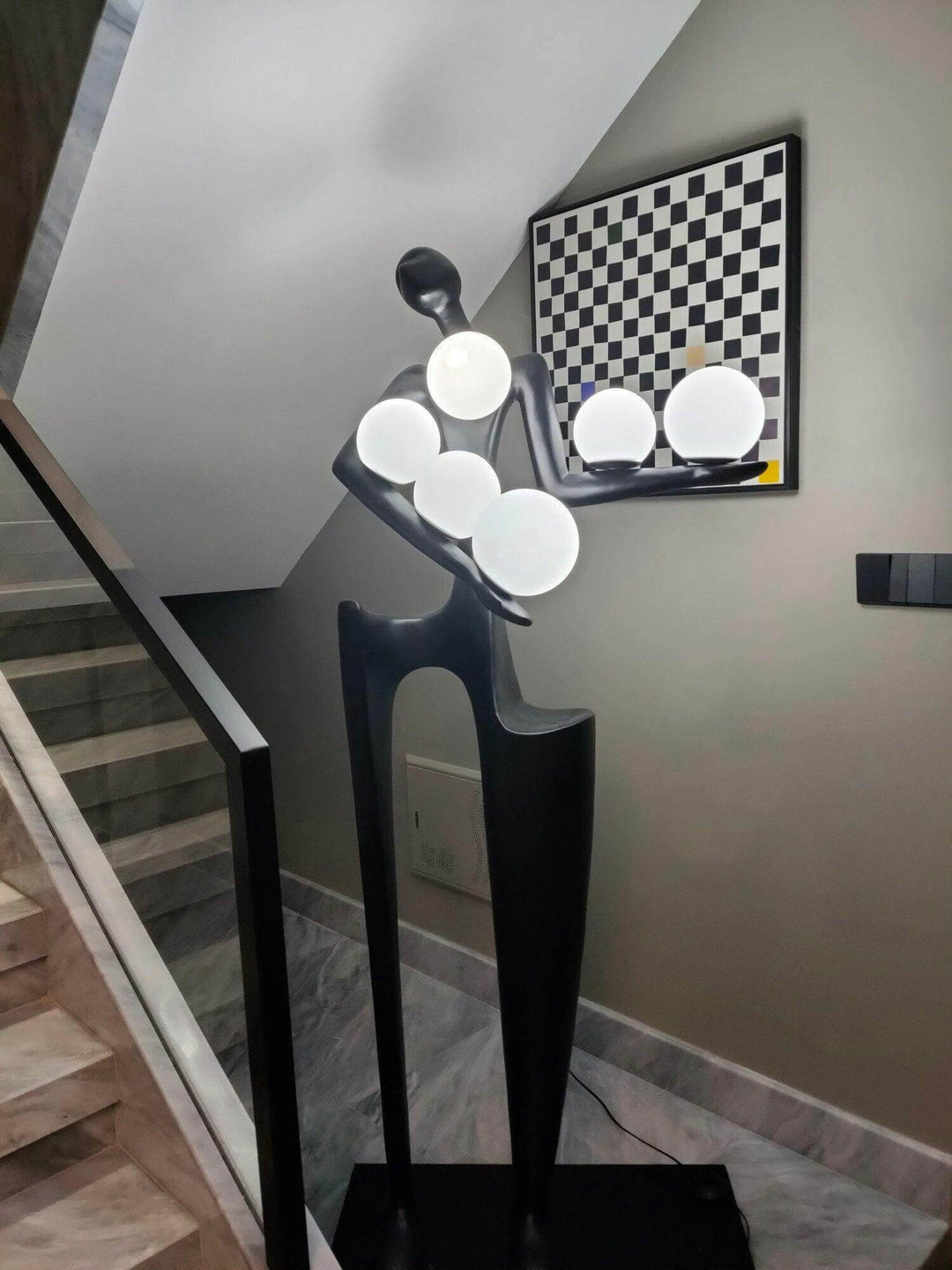 Sculptural floor lamp in modern design with circular light fixtures, perfect for living room decor and art deco style.