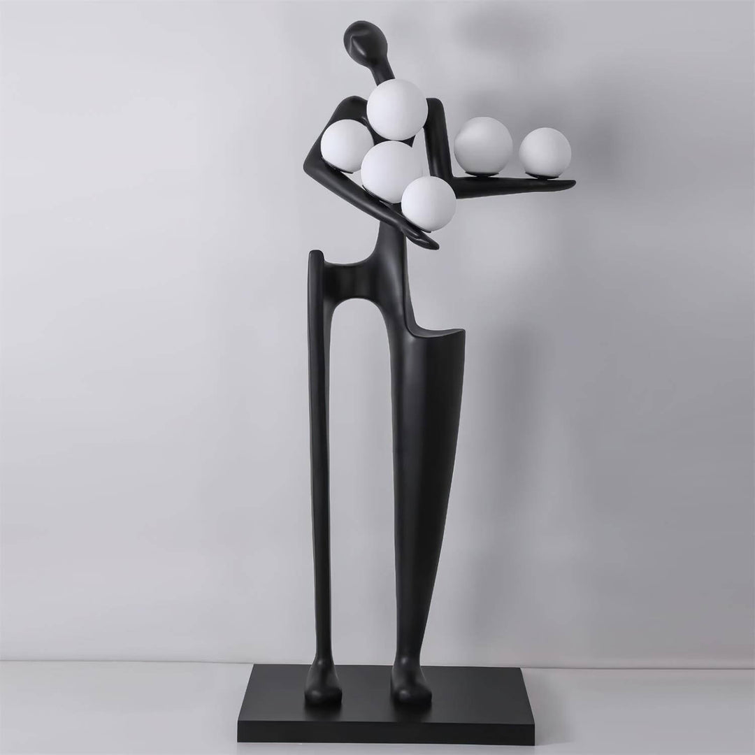 Sculptural floor lamp featuring an art deco design with a unique figure holding spherical lights in a modern living room.