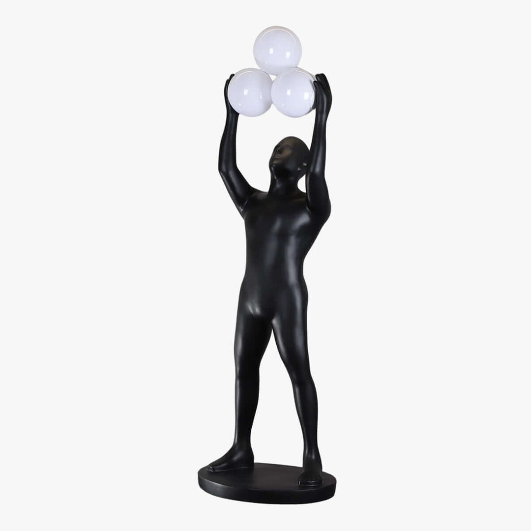 Sculptural floor lamp in black with a figure holding three white globes, perfect for art deco living room decor.