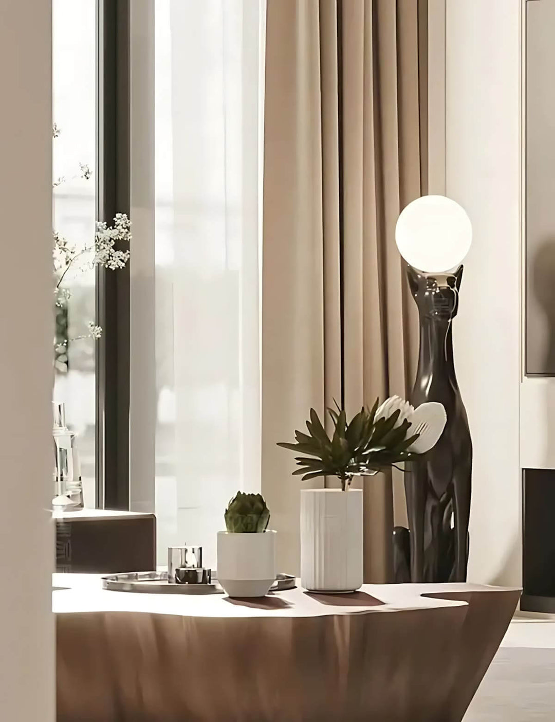 Modern living room featuring a Raveko sculptural floor lamp and elegant decor elements, perfect for art deco aesthetics.