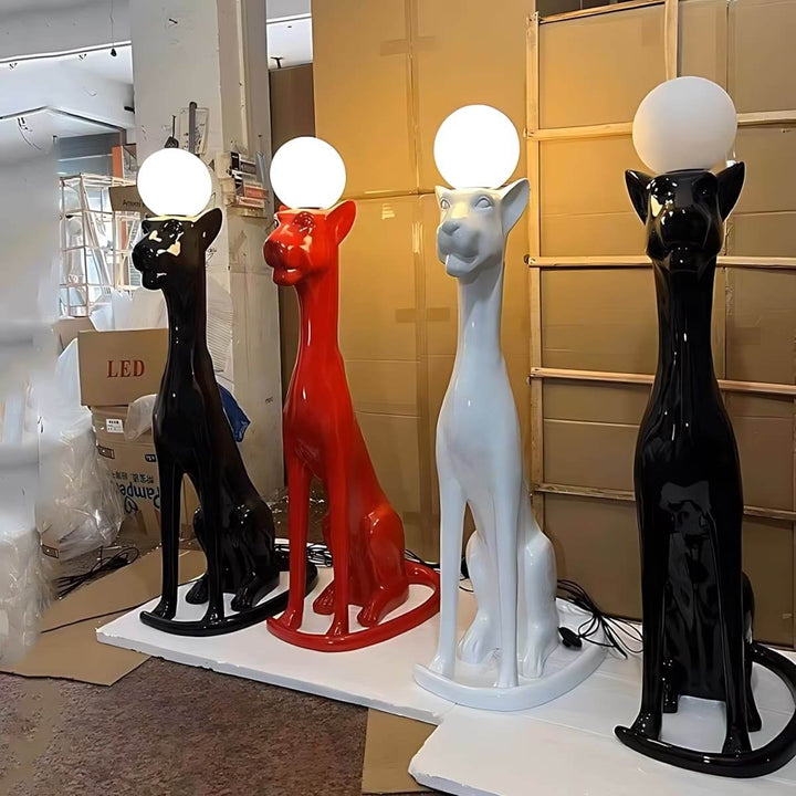 Colorful sculptural dog floor lamps with globe lights in black, white, and red, perfect for modern living room decor.