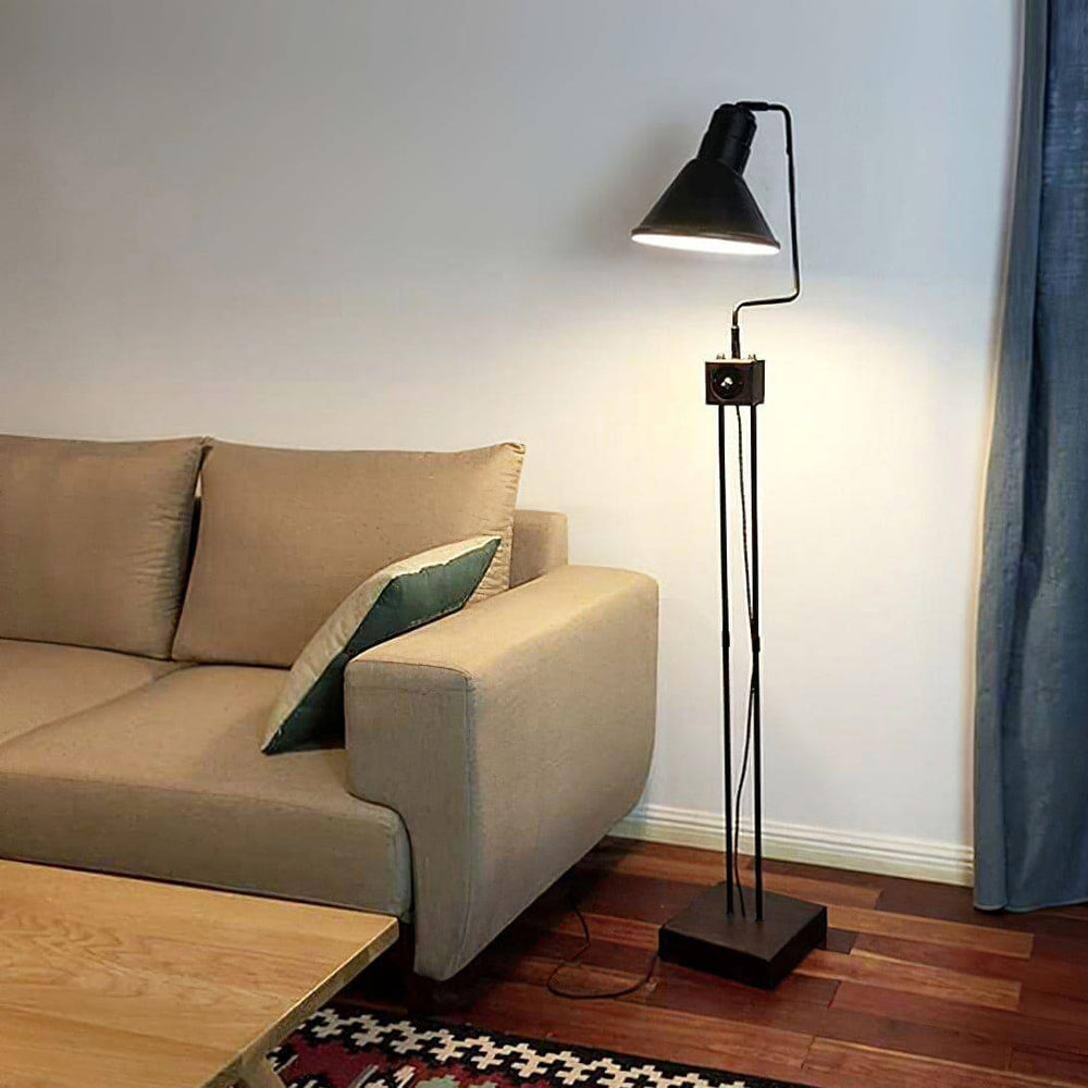 Retro Toia industrial floor lamp in black, ideal for corners beside a beige sofa, enhancing modern living space decor.