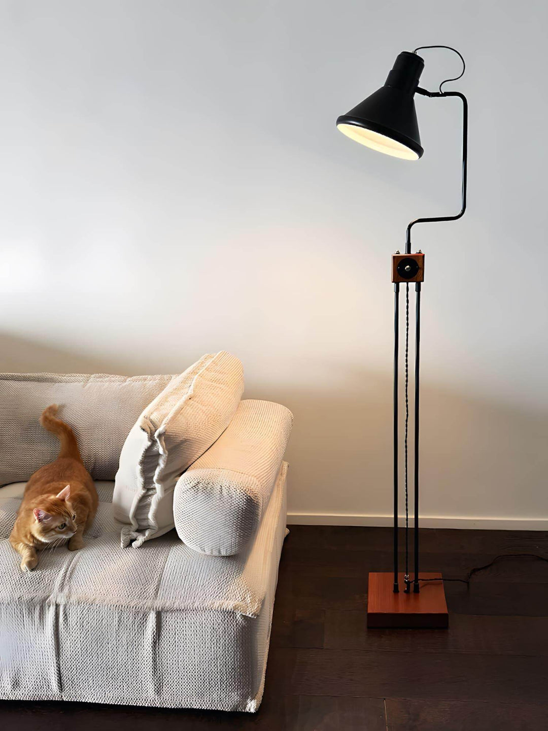 Retro Toia Floor Lamp in black beside a cozy sofa, ideal as an industrial corner floor lamp, adding style to your space.
