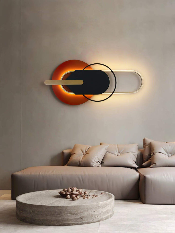 Contemporary round and oval wall light sconces in modern living room setting with stylish gray sofa.