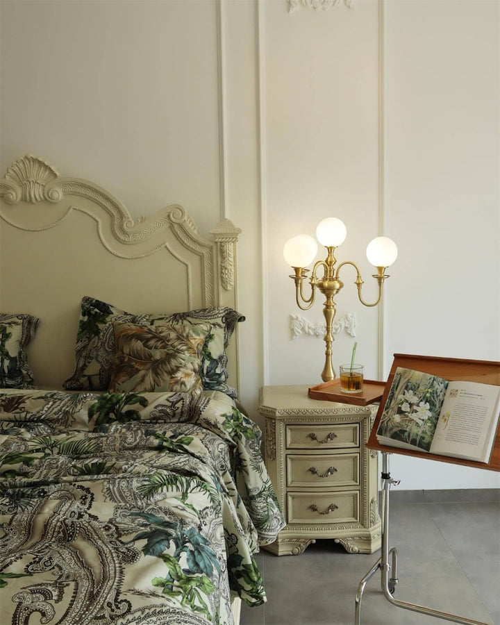 Solora brass table light beside an elegant bed, enhancing a mid-century modern living room aesthetic.