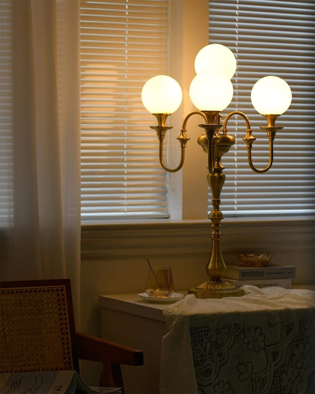 Solora brass table light with three globes, perfect for mid century modern decor, illuminating any living room space.