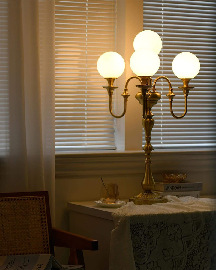 Solora brass table light with three globes, perfect for mid century modern decor, illuminating any living room space.