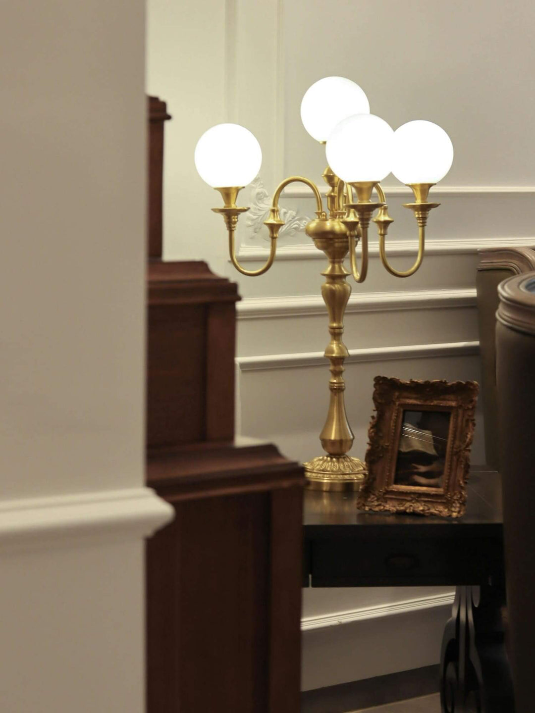 Solora brass table light with four globe bulbs, perfect for a mid-century modern living room.