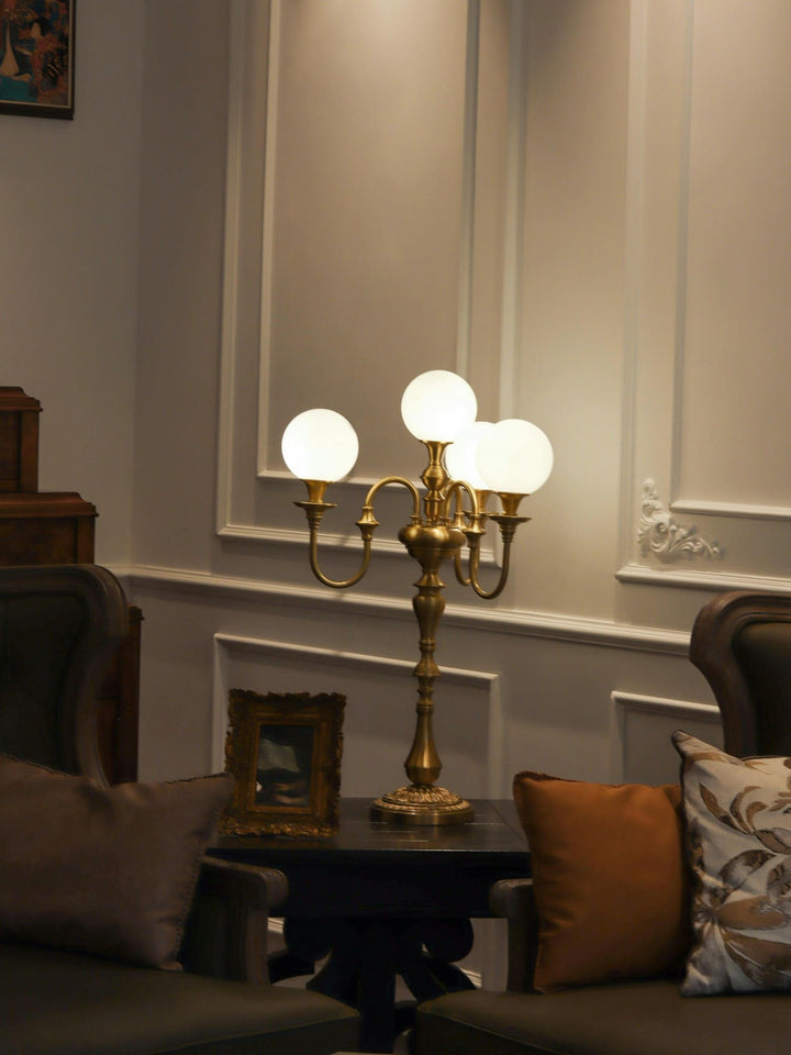 Elegant brass table light with four globe bulbs, perfect for mid-century modern living room decor.