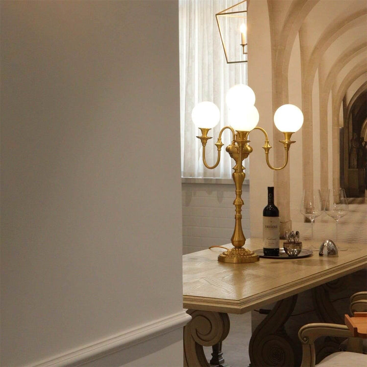 Elegant brass table light with three globes, perfect for mid-century modern living room decor.