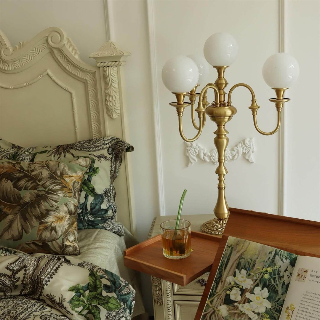 Stylish Solora brass table light beside a cozy bed, perfect mid century modern table lamp for your living room.