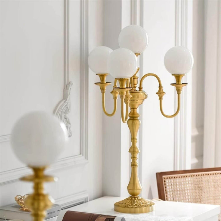 Elegant Solora brass table light with five globes, perfect mid century modern style for living room decor.