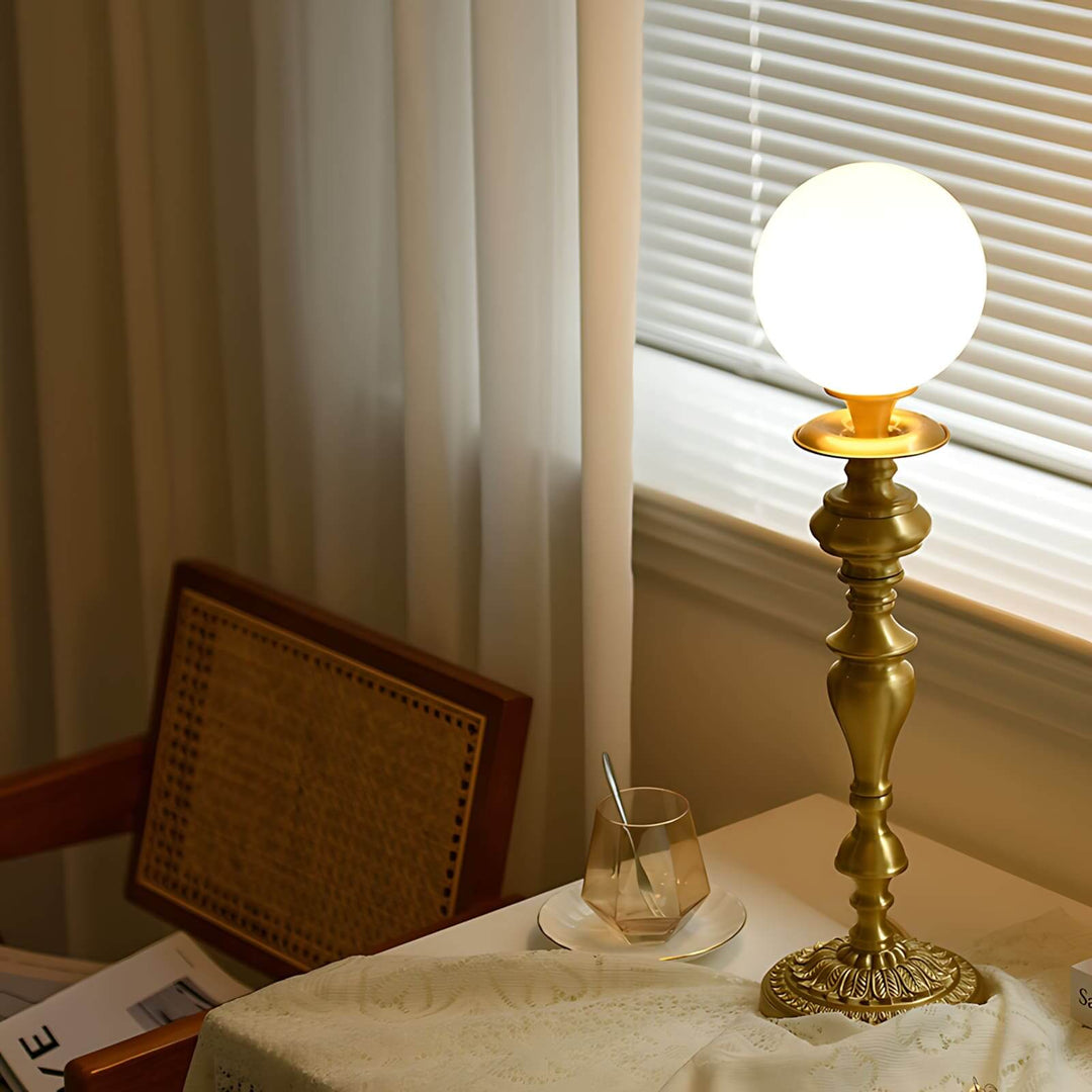 Elegant brass lamp featuring a vintage design with a milk glass globe, perfect for living room table lighting.
