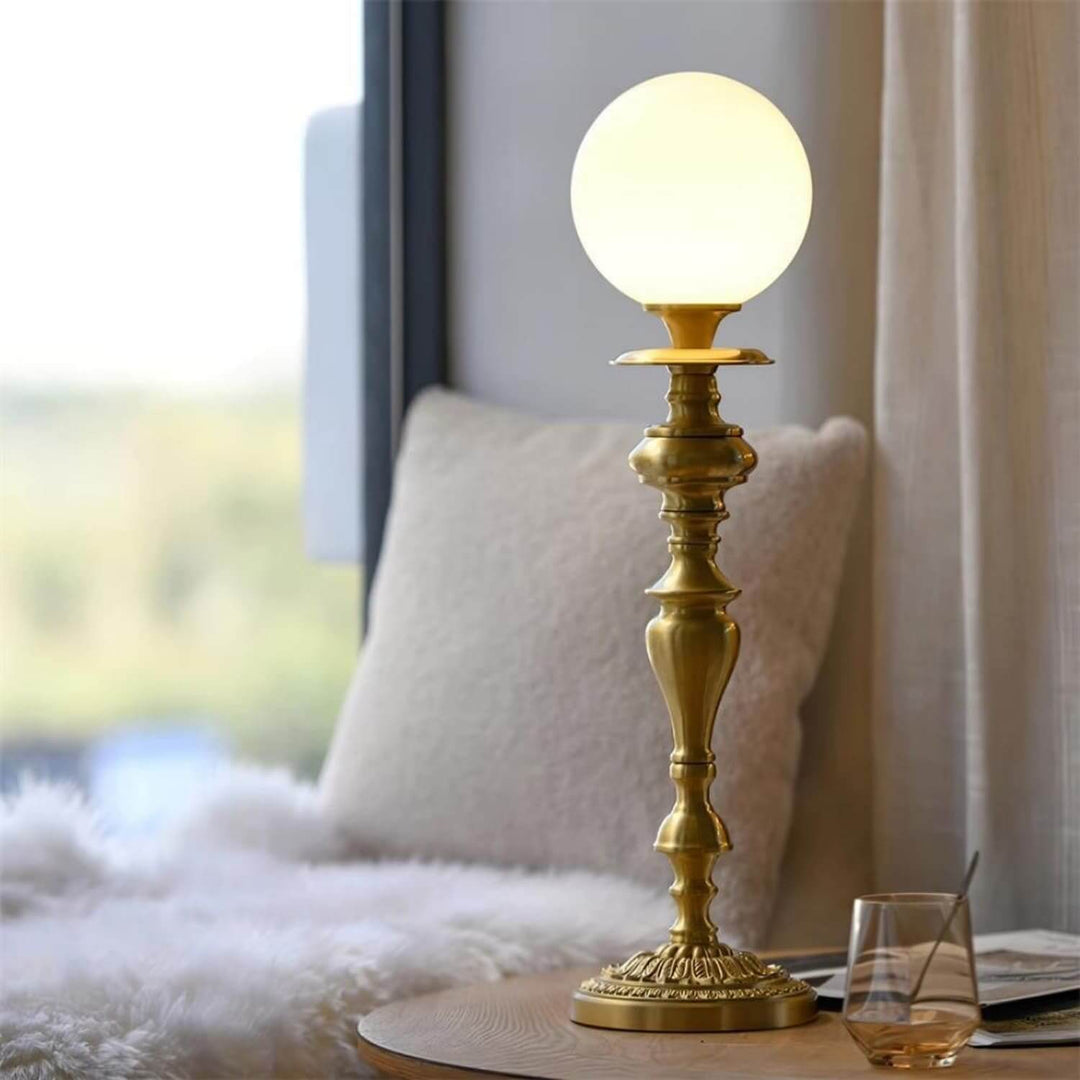 Elegant brass lamp with a round milk glass globe, perfect for vintage decor in living rooms or stylish table lights.