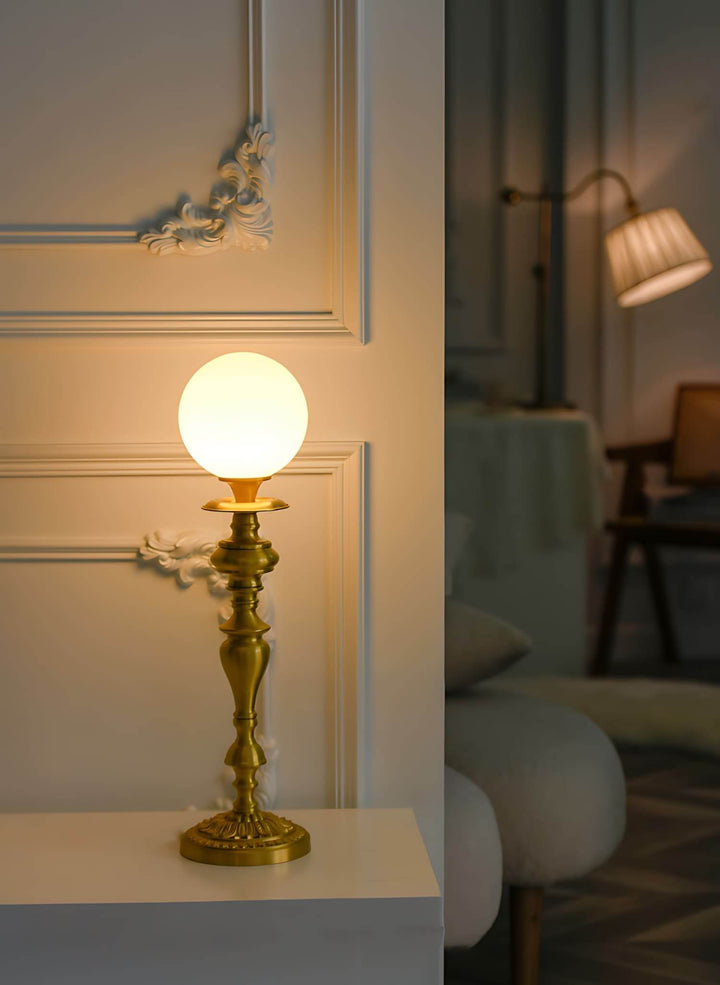 Solora table light in brass featuring a vintage milk glass orb, ideal table lamp for living room decor.