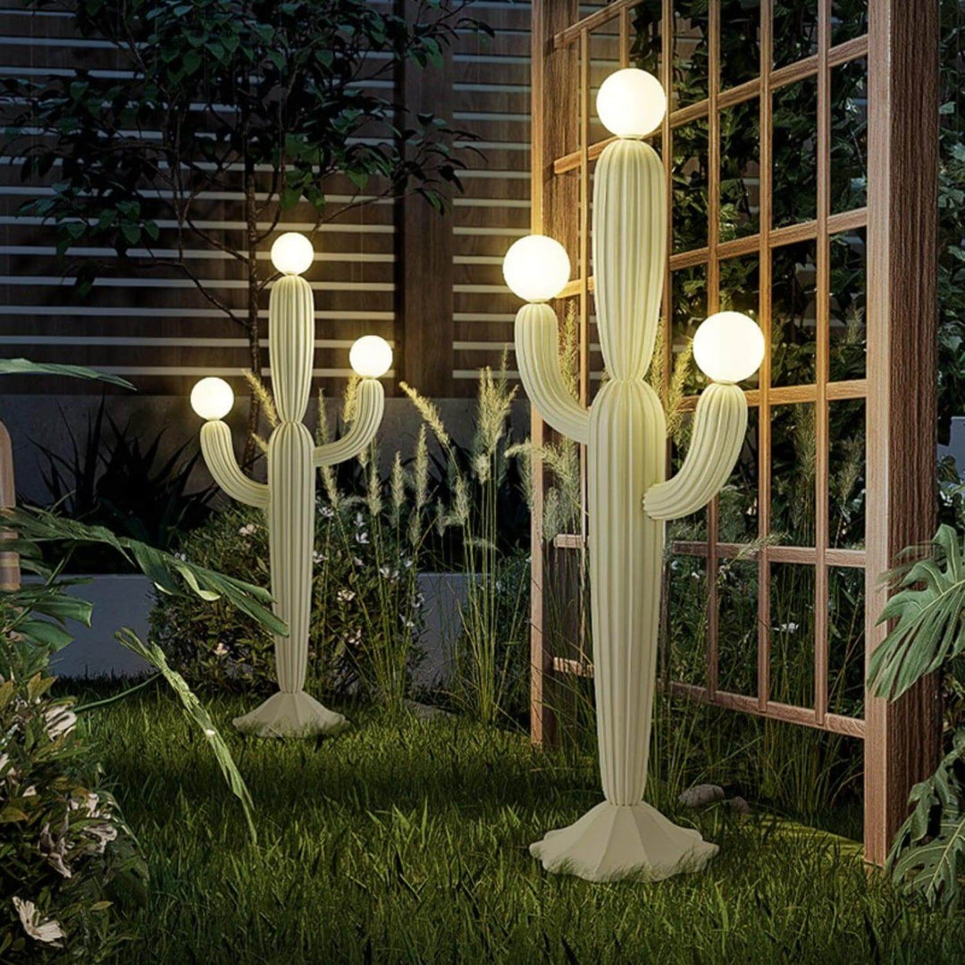 Stylish cactus floor lamp in garden setting, featuring a sculptural design with glowing globes, ideal for art deco decor.