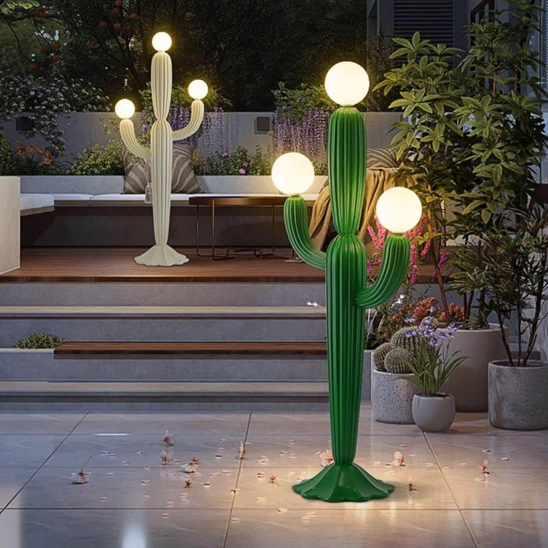 Stylish green cactus floor lamp and white lamp in modern outdoor setting, perfect as a sculptural art deco lighting piece.