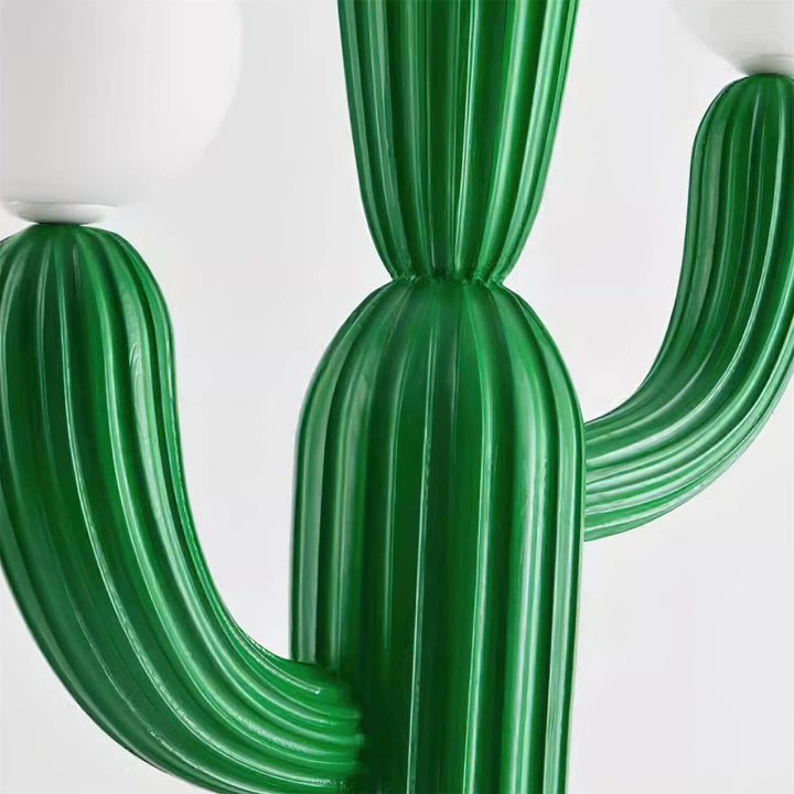 Close-up of a green sculptural cactus floor lamp, showcasing its art deco design and textured detailing.