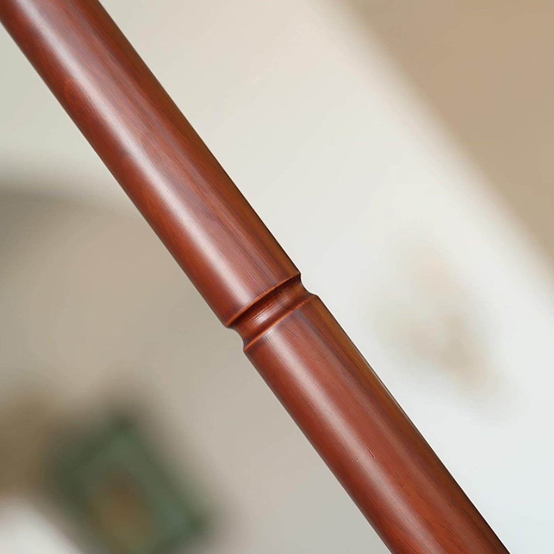 Close-up of the wooden base of the Suki Pleated Floor Lamp, showcasing its mid-century modern design and sleek finish.