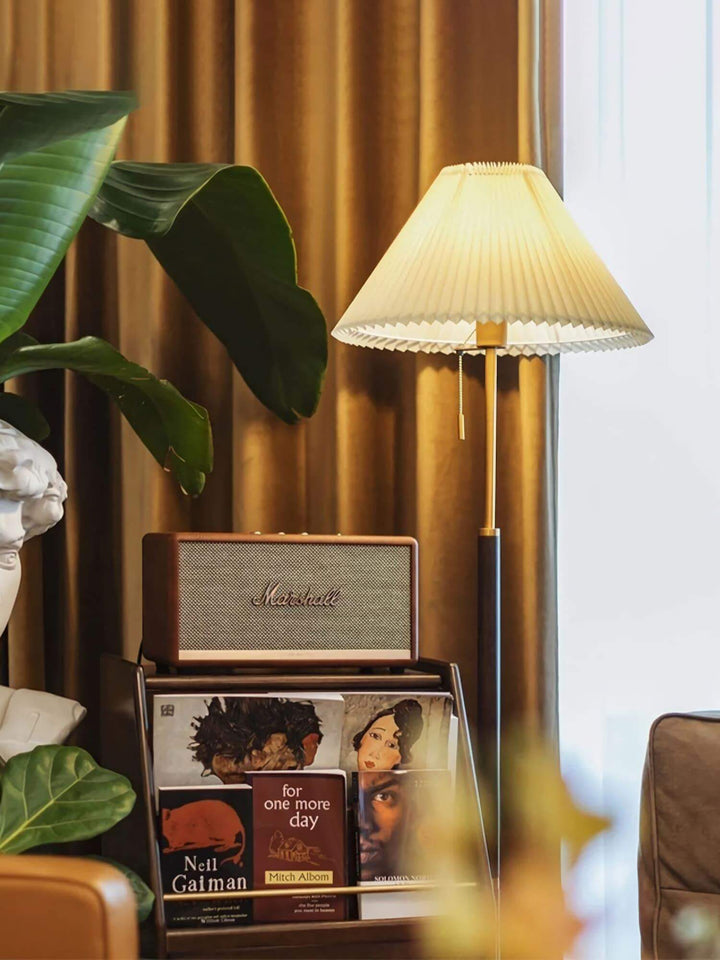 Suki Pleated Floor Lamp next to a record player and vinyl collection in a stylish living room setting.