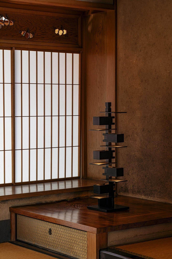 Taliesin table lamp in a serene setting, featuring artistic design and wood base, ideal for living rooms and art deco decor.