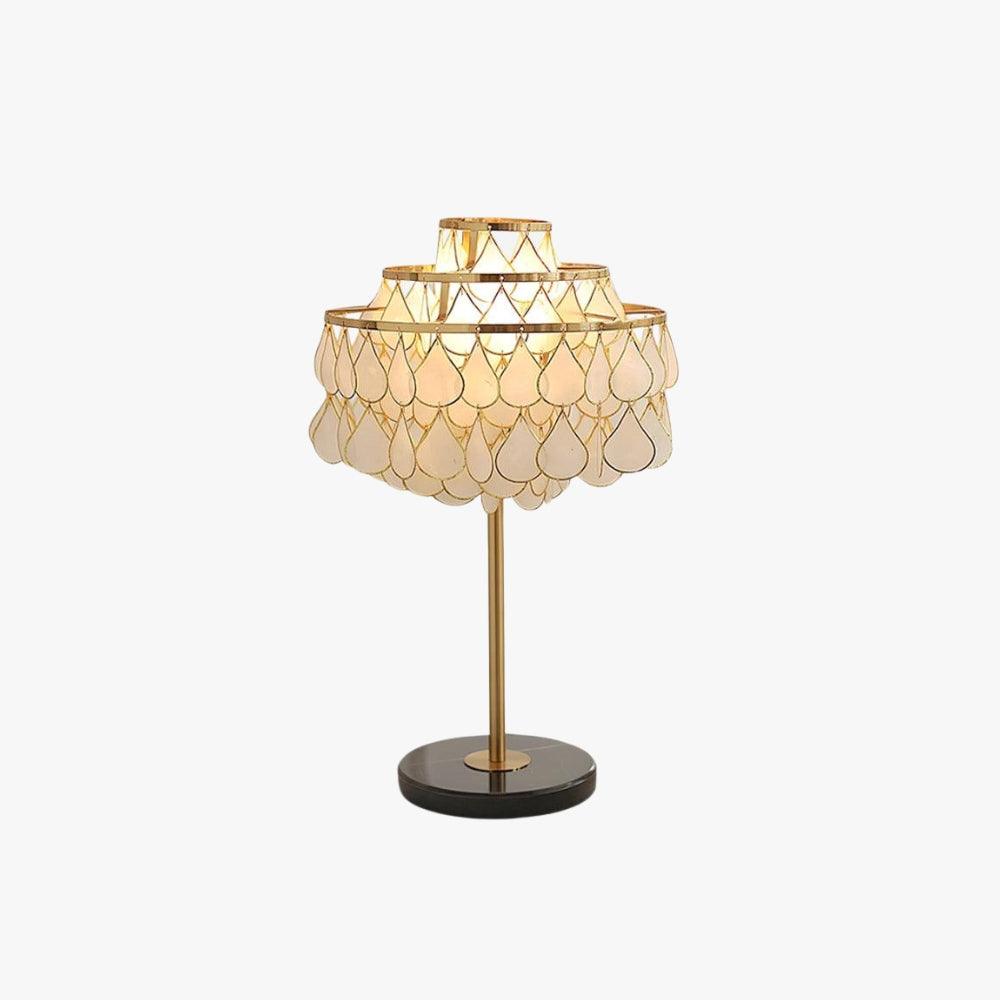 Teardrop shell table lamp with brass base, ideal for coastal decor and luxury bedside lighting.