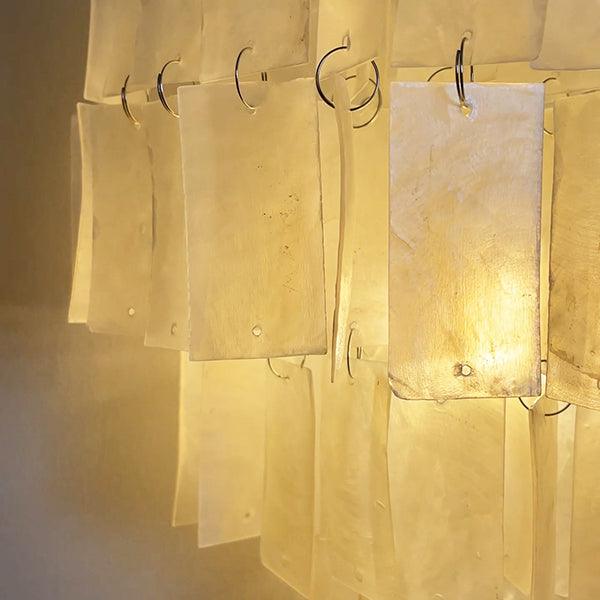 Tiered wall lamp showcasing a shell wall sconce design, perfect for coastal decor or bedside lighting.