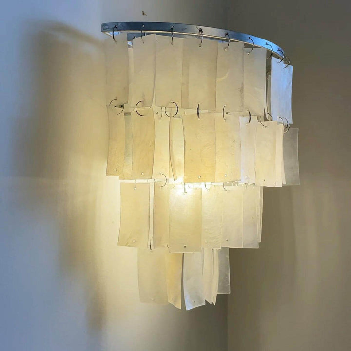 Elegant tiered shell wall sconce, perfect as a coastal bedside wall light, 9.8" x 9.8" design, warm and inviting glow.