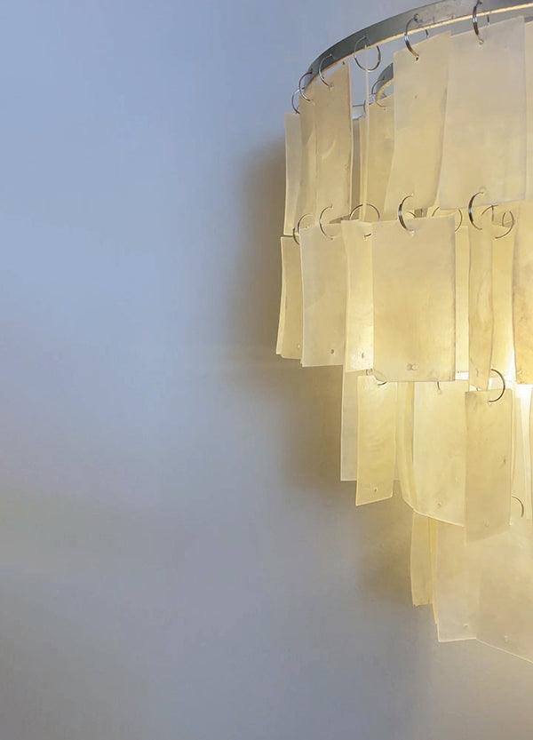 Stylish tiered wall lamp featuring shell design; perfect coastal bedside wall sconce lighting. Size: 25cm x 25cm.