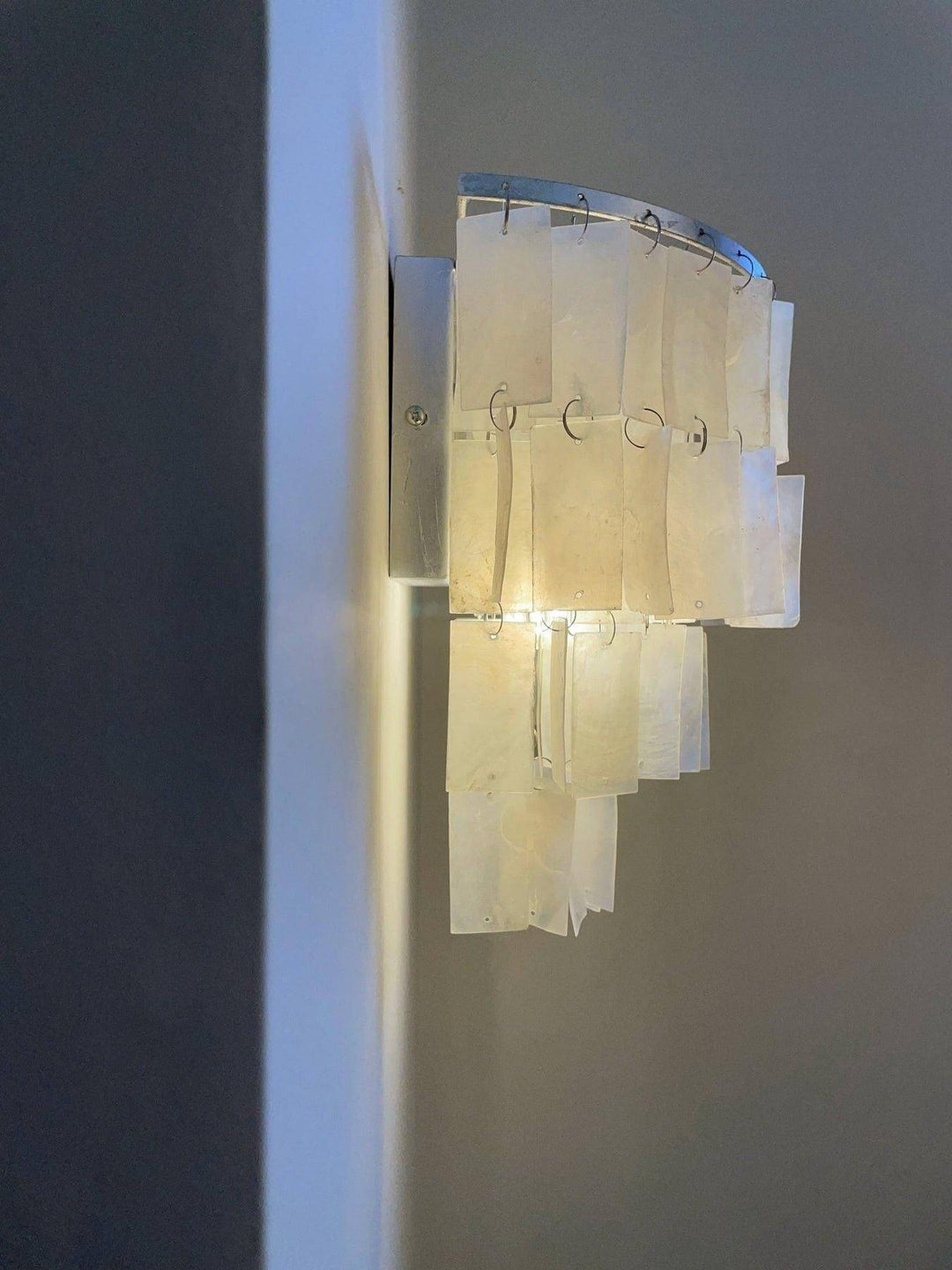 Elegant tiered wall lamp with shell design, perfect as a coastal wall sconce or bedside wall light.