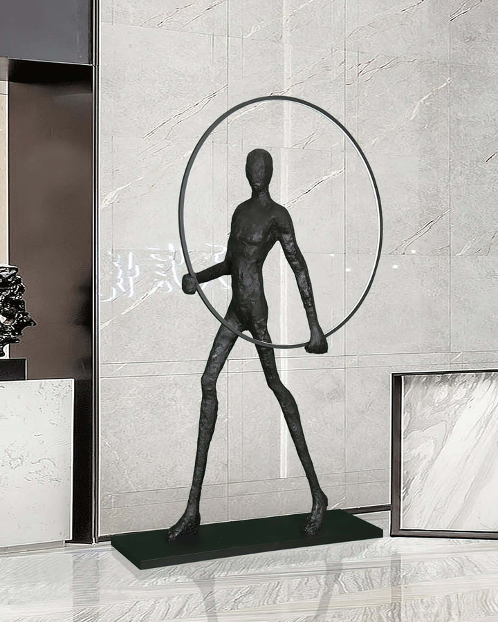 Sculptural floor lamp featuring a slender figure holding a hoop, ideal for modern living room decor.