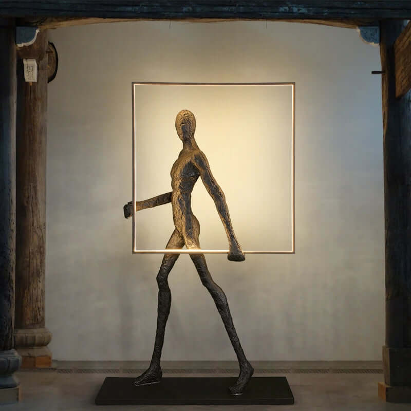 Sculptural floor lamp in art deco style with figure design illuminating a room.