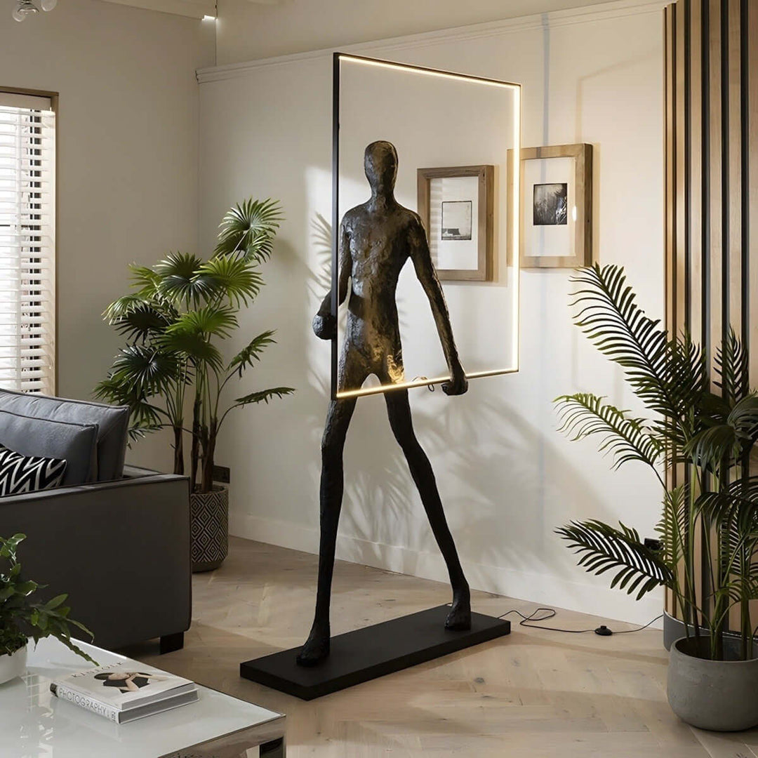 Sculptural floor lamp in a modern living room, showcasing art deco style with elegant lighting and stylish decor.