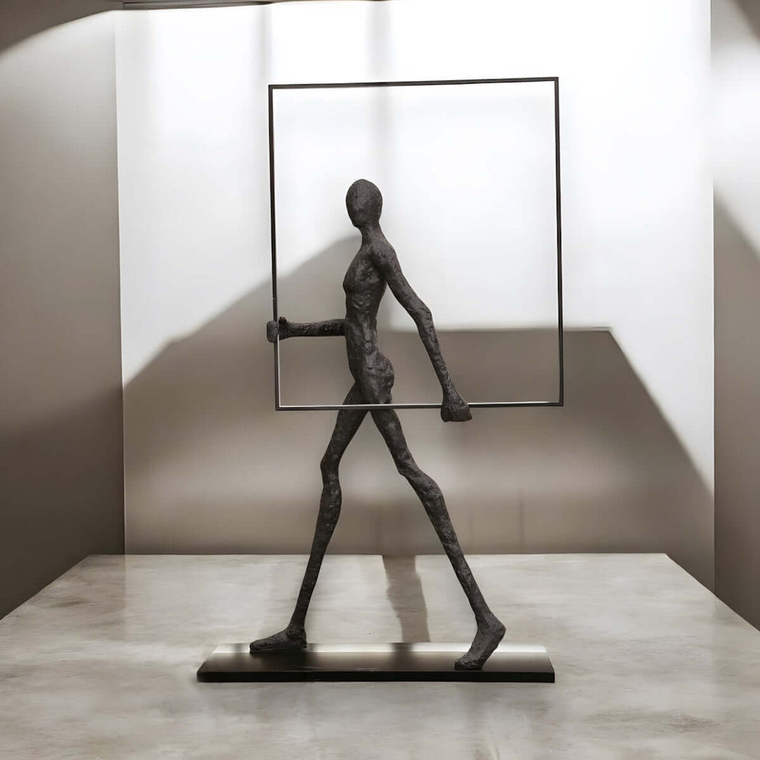 Artistic sculpture of a slender figure walking with a frame, modern decor for stylish interiors.
