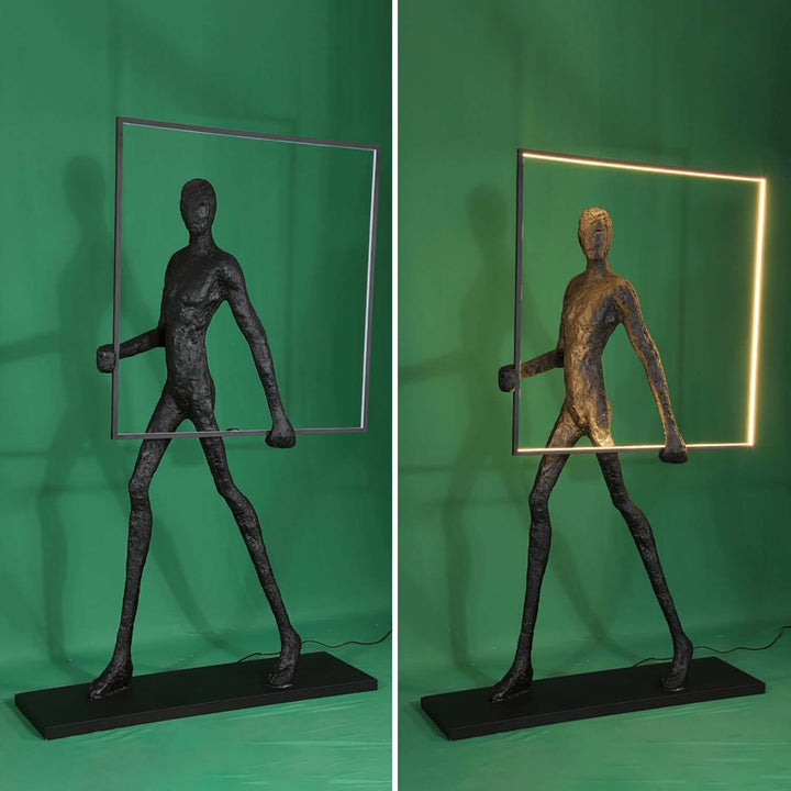 Sculptural art deco floor lamp featuring a human figure holding a square frame, ideal for living room decor.