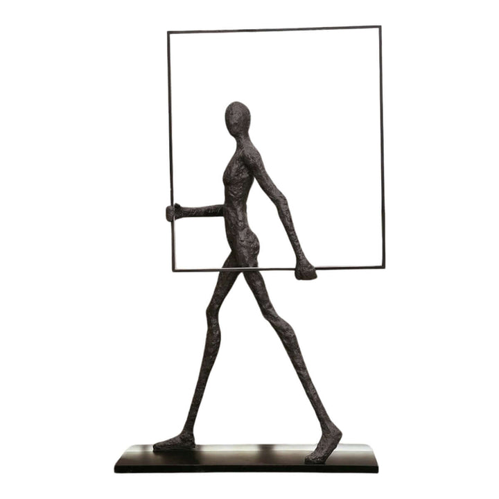 Sculptural figure holding a frame, modern art piece for contemporary decor.