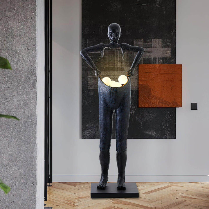 Sculptural art deco floor lamp in living room, resembling a human figure with glowing orbs, perfect floor lights for modern decor.