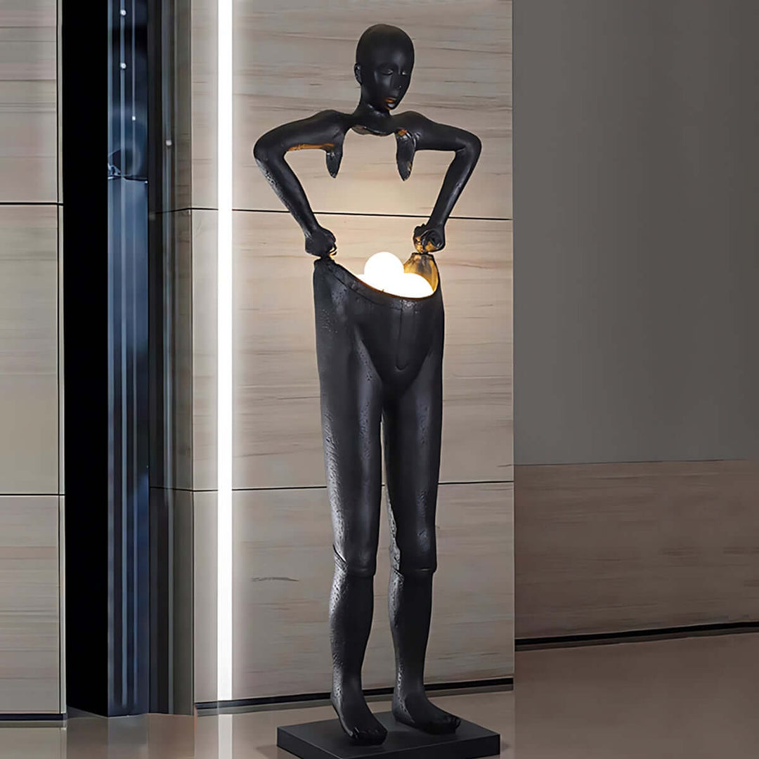 Sculptural floor lamp in art deco style depicting a figure holding a light, perfect as floor lights for living room decor.