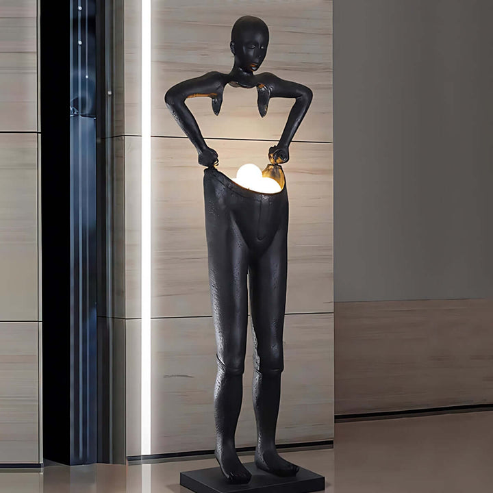 Sculptural floor lamp in art deco style depicting a figure holding a light, perfect as floor lights for living room decor.
